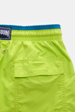 Vilebrequin Swim shorts 'Moka' neon green/teal shown from the back close-up, highlighting elastic waistband, back pocket with flap and drainage eyelets. The high-quality microfibre fabric ensures a light touch and comfort. Features include an elasticated 