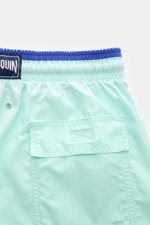 Vilebrequin Swim shorts 'Moka' mint green/dark blue shown from the back close-up, featuring elastic waistband, back pocket with flap, turtle stitching, drainage eyelets, side pockets, mesh lining, and VILEBREQUIN woven label for comfort and style.