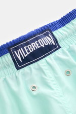 Vilebrequin Swim shorts 'Moka' mint green/dark blue close-up rear view showing elastic waistband, VILEBREQUIN label, and drainage eyelets.