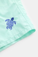 Close-up front-side view of Vilebrequin Swim shorts 'Moka' mint green/dark blue showing turtle stitching on high-quality microfiber fabric.