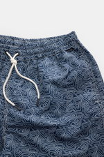 Close-up top view of 04651/ A trip in a bag Swim shorts 'Seamap' navy/white patterned, quick-drying microfibre with nautical chart print, elasticated waistband, drawstring, side and back pockets, short hem vents, and mesh lining.