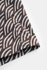 Close-up side view of Moorer Swim shorts dark brown/smoky blue patterned, showing fabric and stitching details. Features quick-drying microfibre, smooth feel, regular fit, elasticated waistband with drawstring, small key pocket inside, side seam pockets, 