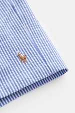 Close-up side view of Polo Ralph Lauren Swim shorts 'Traveler' blue/white striped with embroidered logo on seersucker fabric.

<p>Stylish confidence for your travels: These POLO RALPH LAUREN swim shorts are the perfect companion for your next holiday in t
