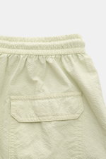 Close-up rear view of 04651/ A trip in a bag Swim shorts 'Mono Seersucker' sage, featuring elastic waistband and back pocket with flap. Perfect for your next summer holiday: With their design in seersucker look, these swim shorts by 04651/ A TRIP IN A BAG