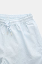 Close-up front view of 04651/ A trip in a bag Swim shorts 'Mono Seersucker' pastel blue with elastic waistband and drawstring, seersucker microfiber fabric.

Description: <p>Perfect for your next summer holiday: With their design in seersucker look, these