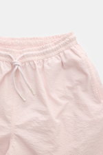 Close-up front view of 04651/ A trip in a bag Swim shorts 'Mono Seersucker' rose in light pink seersucker fabric with elastic waistband and drawstring. 

Perfect for your next summer holiday: With their design in seersucker look, these swim shorts by 0465