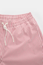 Close-up front view of 04651/ A trip in a bag Swim shorts rose/burgundy striped with elasticated waistband and white drawstring.

<p>Perfect for your next summer holiday: With their modern striped pattern, these swim shorts by 04651/ A TRIP IN A BAG are a