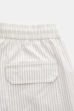 Close-up rear view of 04651/ A trip in a bag Swim shorts light grey/white striped showing elastic waistband and back pocket with flap.

<p>Perfect for your next summer holiday: With their modern striped pattern, these swim shorts by 04651/ A TRIP IN A BAG
