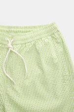 Close-up front view of 04651/ A trip in a bag Swim shorts pastel green/white striped with elastic waistband and drawstring.

<p>Perfect for your next summer holiday: With their modern striped pattern, these swim shorts by 04651/ A TRIP IN A BAG are an eye