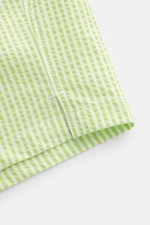 Close-up view of the hem and side vent of 04651/ A trip in a bag Swim shorts pastel green/white striped with seersucker fabric and neat stitching.

<p>Perfect for your next summer holiday: With their modern striped pattern, these swim shorts by 04651/ A T