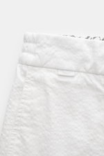 Close-up top view of 04651/ A trip in a bag Badeshorts 'Plain Swim' off-white showing soft, quick-drying microfiber with contrast stitching and elastic waistband with drawstring.