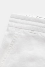 Close-up front view of 04651/ A trip in a bag Linen bermudas 'Linen Bermuda' white showing elasticated waistband with drawstring and French pocket.

Description: <p>These airy Bermudas by 04651/ A TRIP IN A BAG are a must-have for your next beach holiday.