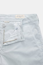 Close-up top-front view of Jacob Cohen Bermudas 'Bob' pastel blue shorts with elasticated cotton, slim fit, button fly, French pockets, and leather patch.