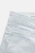 Close-up angled view of Jacob Cohen Bermudas 'Bob' pastel blue shorts showing elasticated cotton, slim fit, low waist, French pockets, button fly, and leather patch. Summer as it should be: The Bermudas 'Bob' by JACOB COHEN combine a casual garment-dyed d