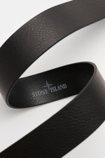 Stone Island Belt black shown from a close-up top angle, featuring elegant cowhide, characteristic grain, matt black pin buckle, one loop, STONE ISLAND embossed logo, small woven label, made in Italy, width 4 cm.