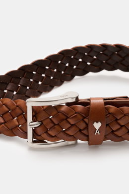 Close-up front angle of Ami Paris Braided belt brown showing braided smooth leather, silver prong buckle, and logo pull-through loop, width approx. 3 cm. Timeless accessory: The braided belt from AMI PARIS proves to be a versatile essential for stylish ou