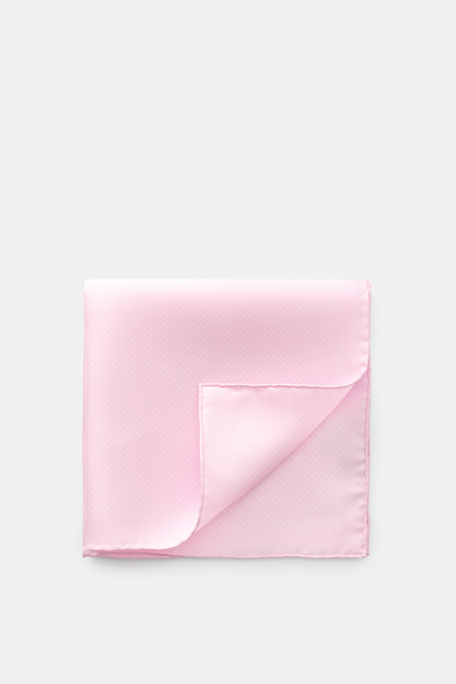 Tom Ford Seiden-Einstecktuch rosé/weiß gepunktet, aus reiner Seide mit rollierten Kanten, kleiner TOM FORD-Print, von oben fotografiert.
