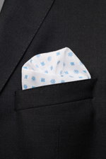 Rosi Collection Linen pocket square 'Fox' white/light blue patterned in black jacket pocket, close-up front view, pure linen, soft feel, floral print, rolled edges, made in Italy, 31.5 cm x 31.5 cm.