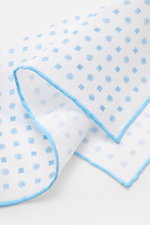 Rosi Collection Linen pocket square 'Fox' white/light blue patterned, pure linen, soft feel, floral print, rolled edges, made in Italy, 31.5x31.5 cm, close-up angled view.