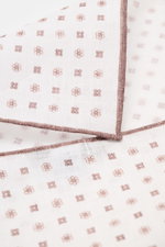Nahaufnahme aus schräger Perspektive des Rosi Collection Leinen-Einstecktuchs "Fox" weiß/braun gemustert mit floralem Print, reines Leinen, weicher Griff, rollierte Kanten, Made in Italy, Maße 31,5x31,5 cm.