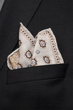 Rosi Collection Silk pocket square 'Easy' grey/brown/smoky blue patterned, pure silk with soft smooth touch, elegant medallion print, floral back, rolled edges, made in Italy, approx. 31x31 cm, shown from front close-up in black jacket pocket.
