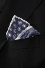 Close-up from above of a Brunello Cucinelli Silk Pocket Square navy/grey-blue dotted folded in a black jacket pocket, showing its dotted pattern and rolled edges.

<p>Subtle elegance for style-conscious appearances: With this finely dotted pocket square, 