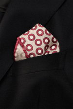 Close-up front view of a Brunello Cucinelli Silk Pocket Square beige/burgundy dotted in a black jacket pocket, showing its rolled edges and smooth silk texture.

<p>Subtle elegance for style-conscious appearances: With this finely dotted pocket square, BR