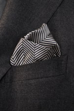 Brunello Cucinelli Silk Pocket Square taupe patterned folded in a dark jacket pocket, photographed from front close-up. Subtle elegance for style-conscious appearances: With this noble pocket square in tonal woven pattern, BRUNELLO CUCINELLI once again em