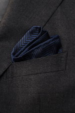Brunello Cucinelli Silk Pocket Square dark navy patterned folded in jacket pocket, close-up front view showing tonal woven pattern and rolled edges. 

Subtle elegance for style-conscious appearances: With this noble pocket square in tonal woven pattern, B