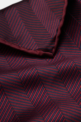 Brunello Cucinelli Silk Pocket Square burgundy patterned shown close-up from above, displaying tonal woven pattern and rolled edges. Subtle elegance for style-conscious appearances: With this noble pocket square in tonal woven pattern, BRUNELLO CUCINELLI 