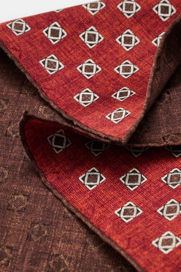 Alt tag (124 characters): Close-up front angle of Brunello Cucinelli Silk Pocket Square sand/beige patterned with ornamental design and rolled edges.

<p>Elegant accent: The silk pocket square from BRUNELLO CUCINELLI with its distinctive ornamental patter