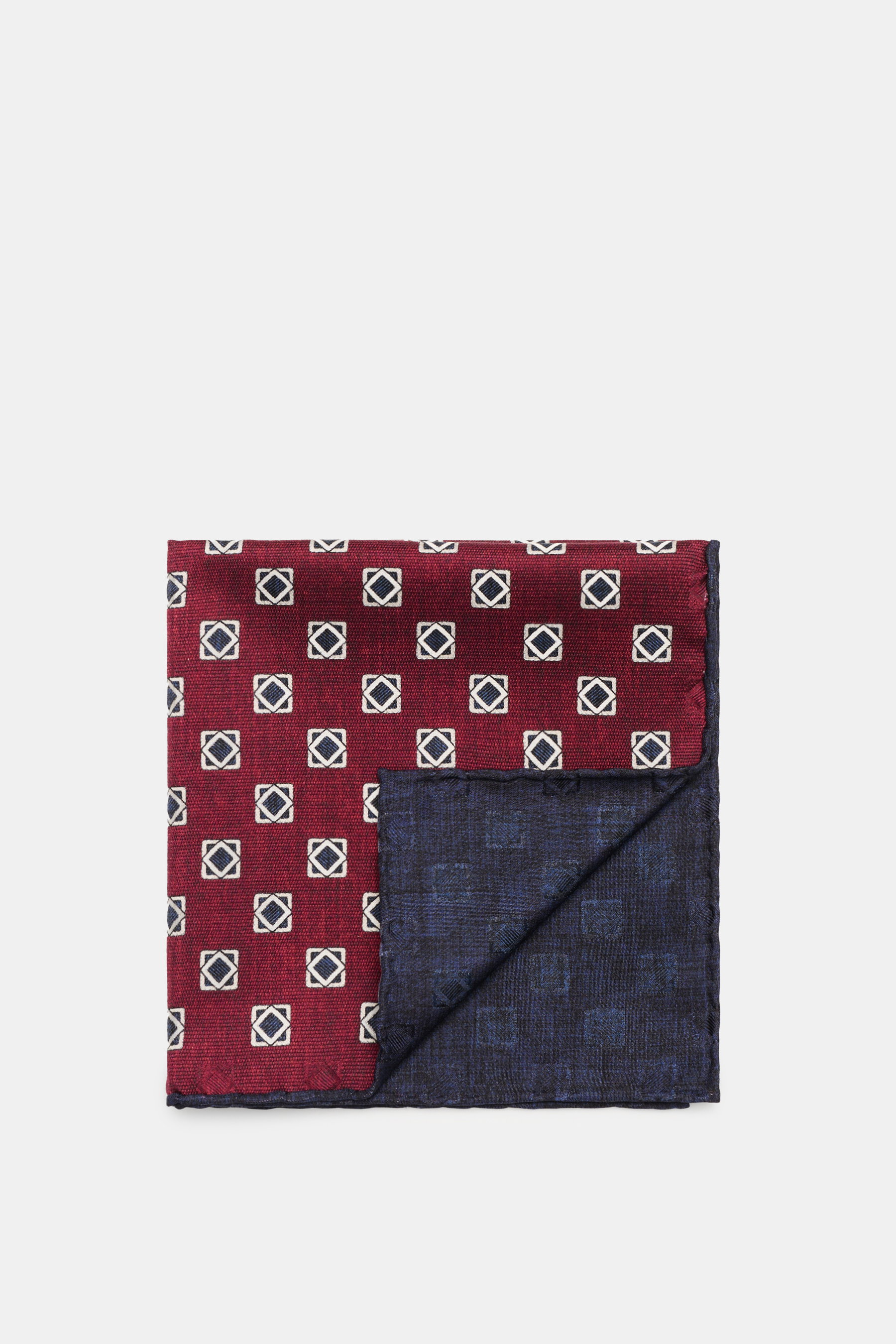 Brunello Cucinelli Silk Pocket Square navy/burgundy patterned shown from top-down, folded to display ornamental pattern and rolled edges.