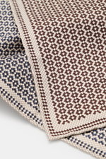 Brunello Cucinelli Silk pocket square dark brown/navy pattern shown from above, pure silk, smooth feel, graphic micro print, rolled edges, Made in Italy, approx. 35 cm x 35 cm.