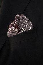 Close-up front view of a Brunello Cucinelli Silk pocket square grey/burgundy pattern in a black jacket pocket, pure silk, smooth feel, graphic micro print, rolled edges, Made in Italy, dimensions approx. 35 cm x 35 cm.
