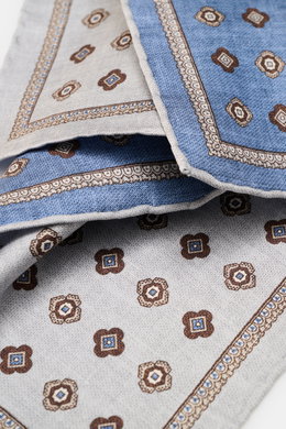 Close-up front angle of the Brunello Cucinelli Silk pocket square silver grey/grey blue patterned, showing medallion design and rolled edges. 

<p>Noble accent: The silk pocket square by BRUNELLO CUCINELLI features a subtle medallion pattern that adds a d