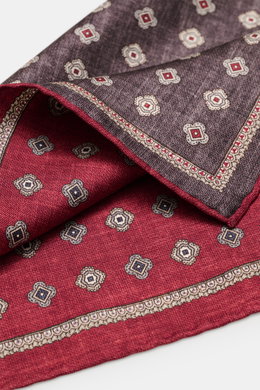 Brunello Cucinelli Silk pocket square dark red/dark grey patterned, close-up from above showing medallion pattern and rolled edges, pure silk.