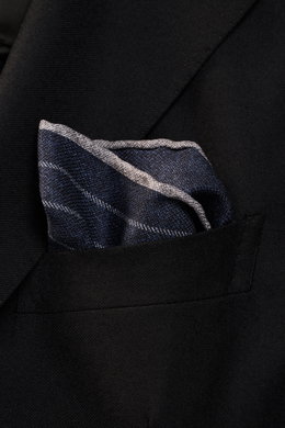 Close-up side view of a Brunello Cucinelli Silk pocket square navy/grey striped, tucked into a black blazer pocket, showcasing its smooth silk fabric and rolled edges.

Description: 
<p>Timeless refinement for sophisticated looks: The silk pocket square b