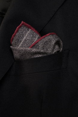 Close-up front-side view of a Brunello Cucinelli Silk pocket square dark grey/light grey/burgundy striped tucked in a black blazer pocket, showing its classic striped pattern with rolled edges.

Description:  
<p>Timeless refinement for sophisticated look