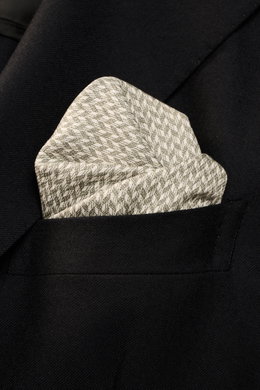 Brunello Cucinelli Silk pocket square sage/cream pattern with graphic micro print, pure silk, smooth feel, rolled edges, Made in Italy, approx. 35x35 cm, photographed close-up from front angle in black jacket pocket.