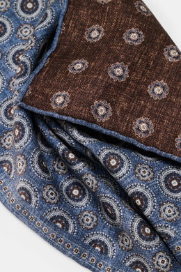 Close-up front view of the Brunello Cucinelli Silk Pocket Square grey blue/brown patterned, showing pure silk fabric with a smooth feel, subtle medallion pattern, and rolled edges.

<p>Noble accent: The silk pocket square by BRUNELLO CUCINELLI features a 