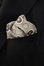 Close-up front view of Brunello Cucinelli Silk Pocket Square grey sage/light grey patterned with medallion design tucked into a black blazer pocket.

<p>Noble accent: The silk pocket square by BRUNELLO CUCINELLI features a subtle medallion pattern that ad