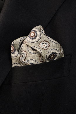Close-up front view of Brunello Cucinelli Silk Pocket Square grey sage/light grey patterned with medallion design tucked into a black blazer pocket.

<p>Noble accent: The silk pocket square by BRUNELLO CUCINELLI features a subtle medallion pattern that ad