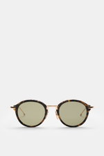 Thom Browne Sonnenbrille dunkelbraun/gold gemustert, rund, Schildpatt-Acetat, Metallbügel mit Tricolore, frontale Nahaufnahme, getönte Gläser, 100% UV-Schutz.