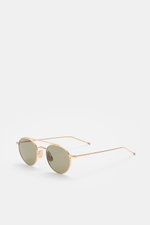 Thom Browne Sonnenbrille gold, runde Form, filigraner Metallrahmen, Tricolore-Detail am Bügel, matte Gläser mit 100% UV-Schutz, seitliche Perspektive.