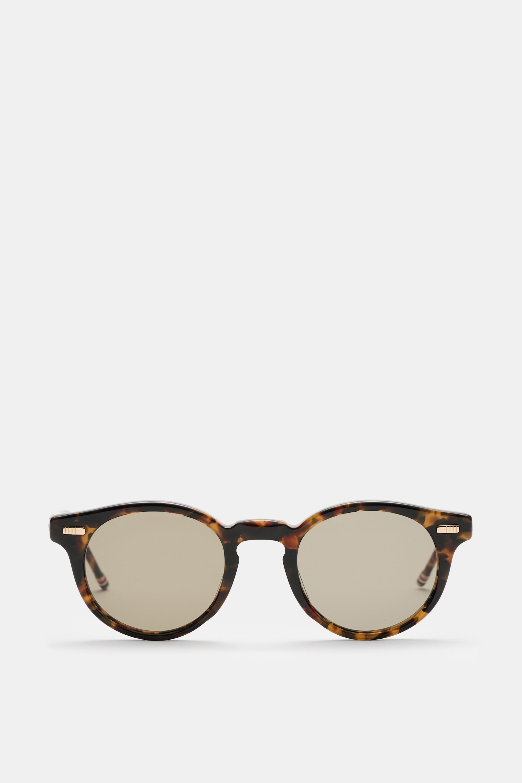 Front view of Thom Browne Sunglasses brown patterned with classic notched bridge shape, evenly tinted plastic lenses, and tortoise acetate frame.

Description: <p>Their classic and elegant notched bridge shape and acetate frame give these sunglasses by TH