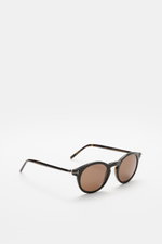 Tom Ford Sonnenbrille 'Private Collection' schwarz/grau gemustert, leicht gerundete Silhouette, Acetat-Rahmen, braune Kunststoffgläser, seitliche Perspektive.