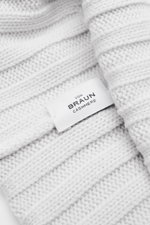 Close-up front perspective of the von Braun Cashmere beanie light grey, showing pure cashmere, soft feel, fine knit, classic rib knit pattern, and small turn-up with label. Whether worn with a classic winter coat or a highly functional down jacket, this s