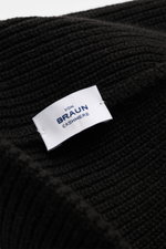 Close-up top view of the von Braun Cashmere beanie black showing fine brioche knit pattern and white label, made of pure cashmere. Wear it with a classic winter coat or high function down jacket: This soft VON BRAUN knitted beanie is made of luxurious cas