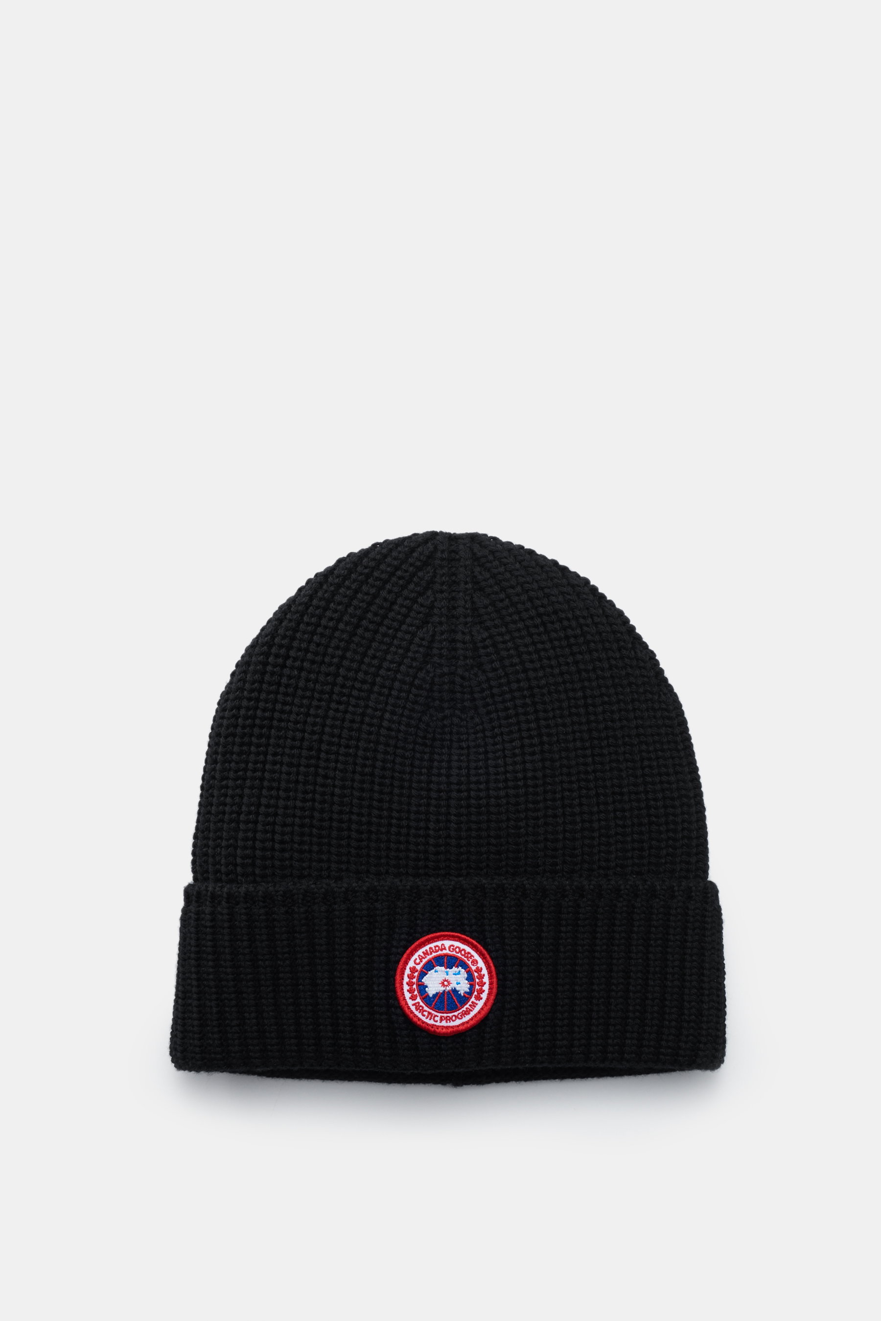 Top-down view of a black Canada Goose Wool beanie with chunky pure wool rib knit, robust fabric, and a fold-up cuff featuring a red and white woven label.

Description: 
<p>A must-have for the colder months: Don’t let bad hair days or cold winter days get
