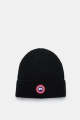 Top-down view of a black Canada Goose Wool beanie with chunky pure wool rib knit, robust fabric, and a fold-up cuff featuring a red and white woven label.

Description: 
<p>A must-have for the colder months: Don’t let bad hair days or cold winter days get